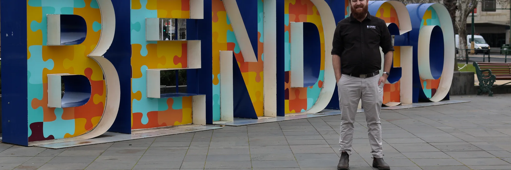 Carl from GARD Systems standing in front of the large coloured BENDIGO letters in Rosalind Park