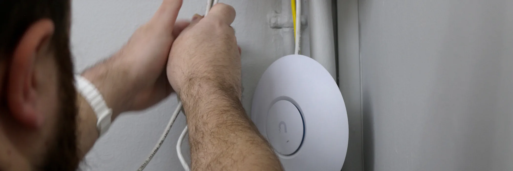 Routing network cabling into a wall-mounted wireless access point